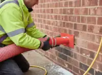 Tradesperson_removing_cavity_wall_insulation